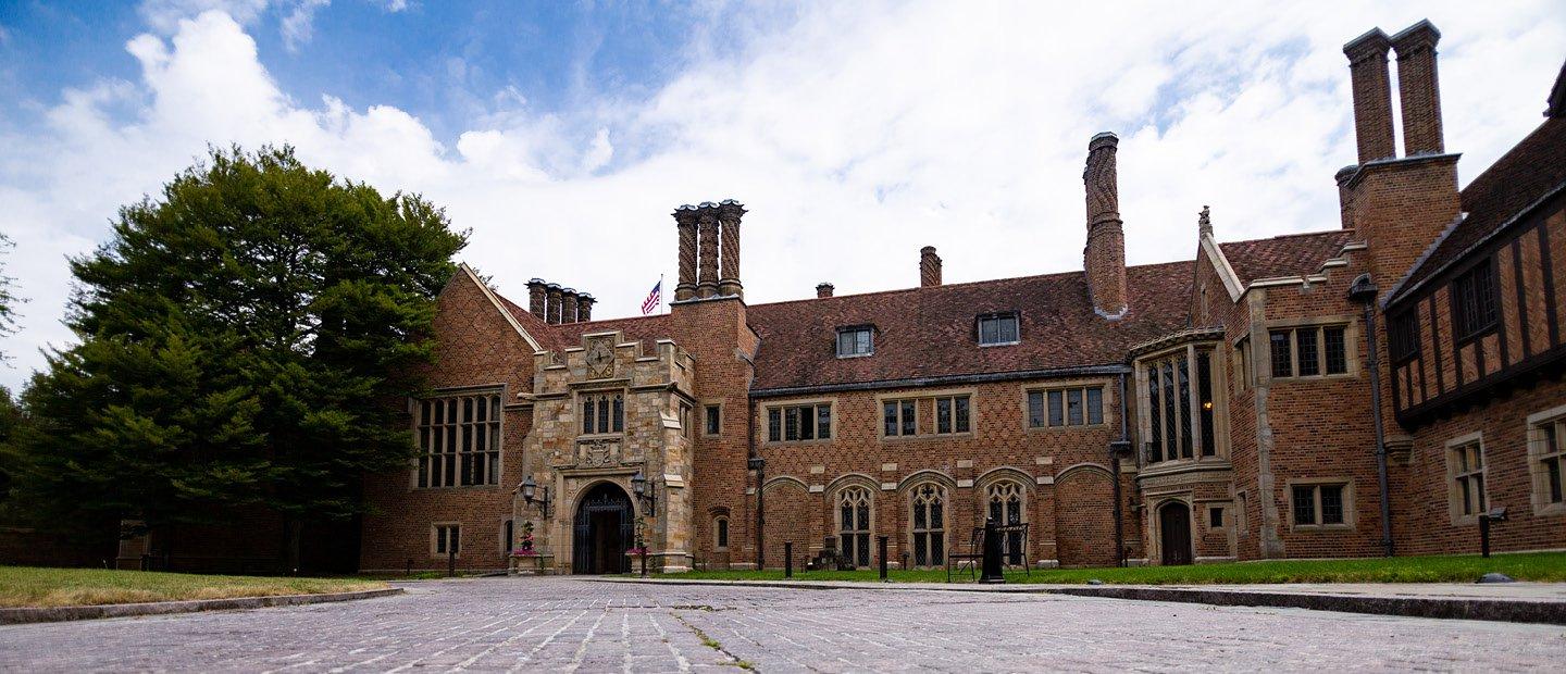 Photo of Meadow Brook Hall, a large historic brown brick building.